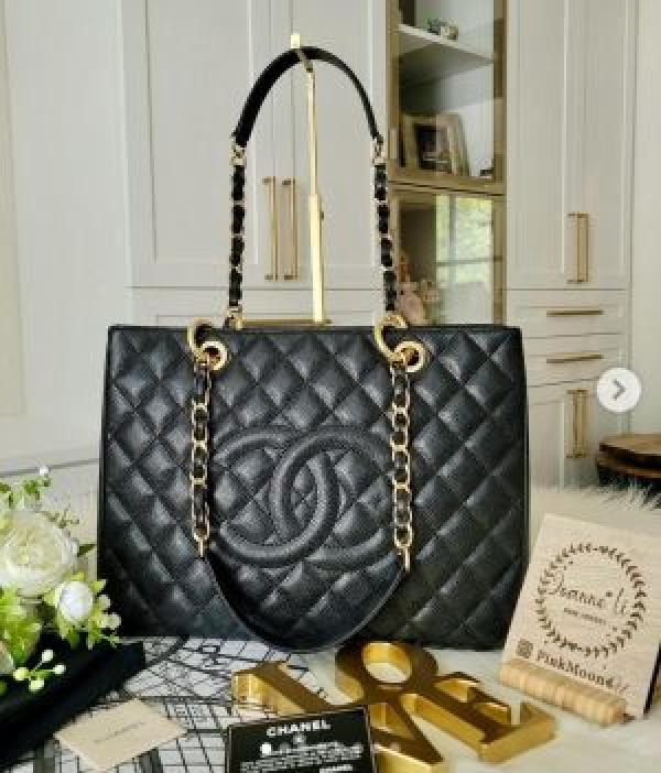 Black Chanel-branded quilted tote with gold-chain straps