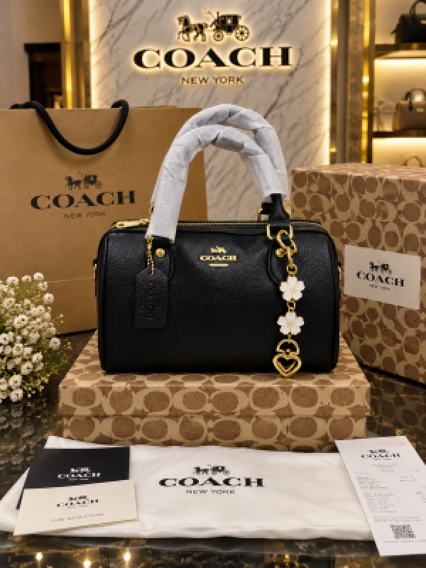 Coach black barrel satchel with top handles and gold-tone detail